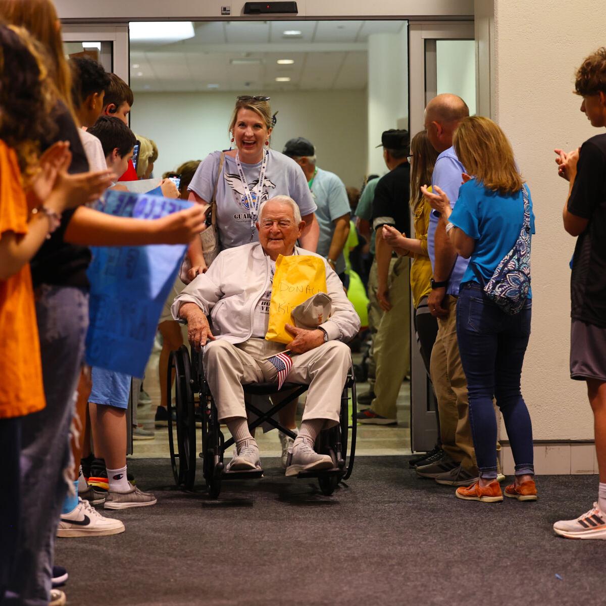 Veteran goes through final part of crowd at Honor Flight Return Home.JPG